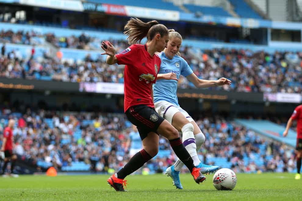 Man United's Abbie McManus battles for the ball against City's Janine Beckie (PA Images)