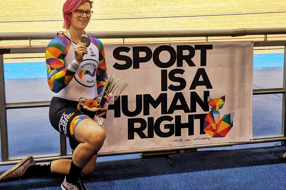McKinnon poses proudly in front of a 'Sport is a human right' banner after defending her sprint title (Rachel McKinnon twitter)