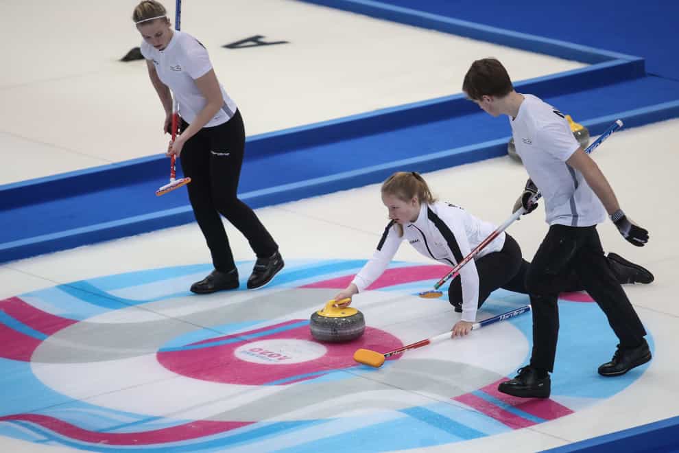 Nora Oestgaard, Lukas Hoestmaelingen and Ingeborg Forbregd on their way to Norway's gold in the mixed curling event (PA Images)