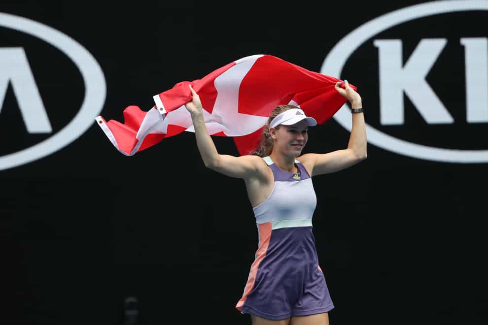 Caroline waves goodbye with a Danish flag (PA Images)