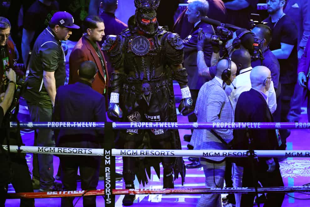 Wilder slowly made his way to the ring draped in his costume and mask (PA Images)