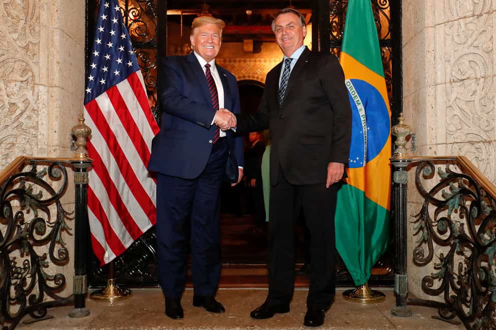 Jair Bolsonaro shook hands with Trump just days before testing positive for coronavirus (PA Images)