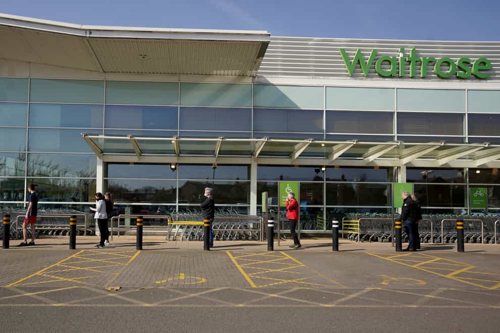 Customers wait at 2 metre intervals outside a Waitrose store (PA Images)