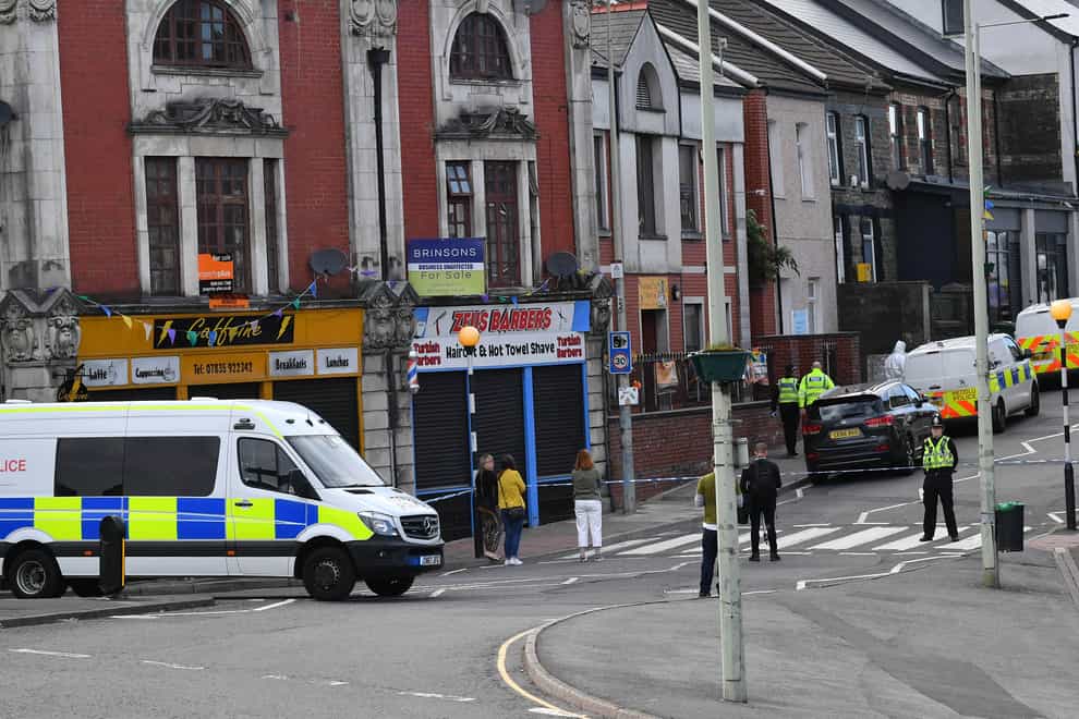 Police at the scene of the stabbing in the village of Pen Y Graig in South Wales