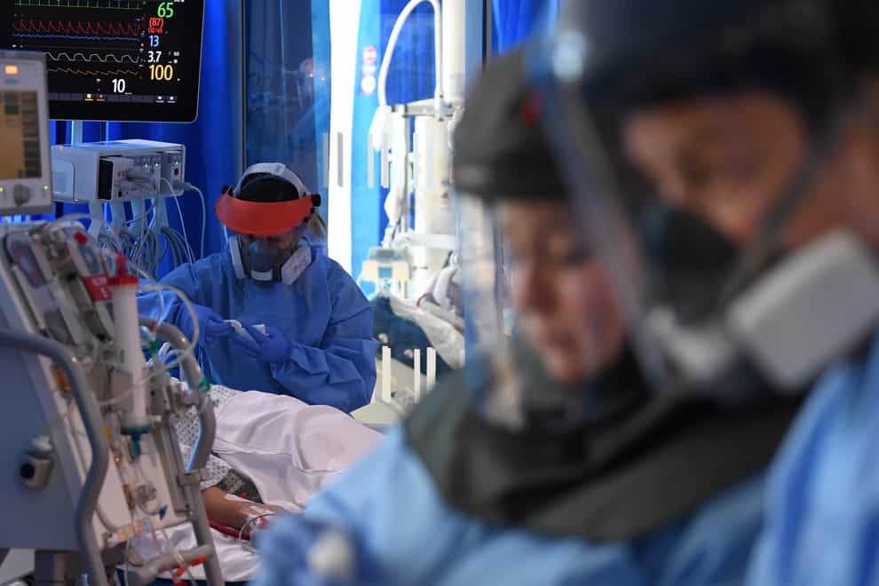 Clinical staff wear Personal Protective Equipment (PPE) as they care for a patient at the Intensive Care Unit at the Royal Papworth Hospital in Cambridge