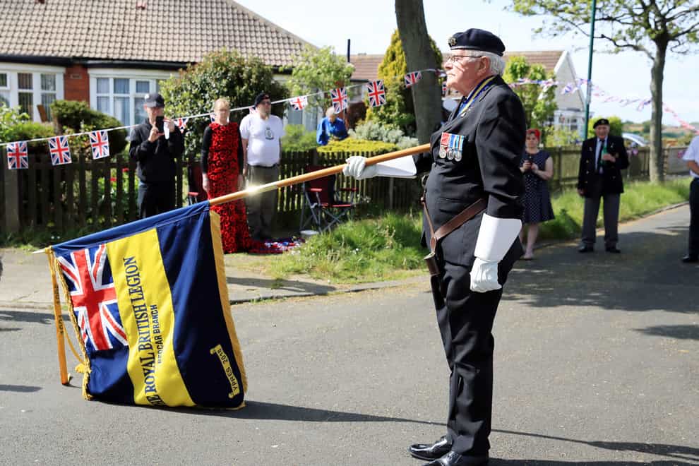 Local Royal British Legion branch chairman Eric Howden, 75, lowers his standard in respect during a two-minute silence in Redcar