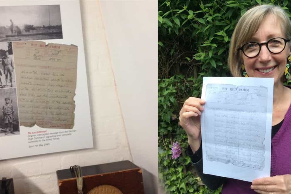 A picture of Dr Jennifer Iles' father's note recording the German surrender at the end of the Second World War - Dr Iles stands with a photocopy on the right
