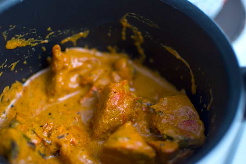 A curry cooking in a pan
