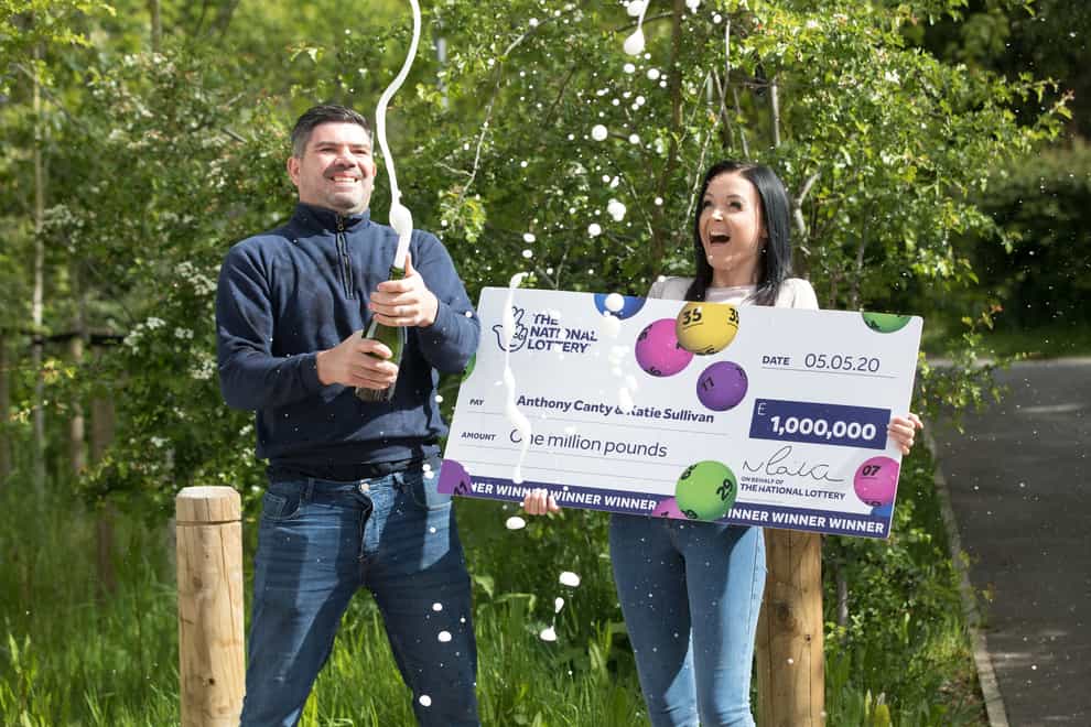 Anthony Canty, who won £1 million in the EuroMillions UK Millionaire Maker draw, celebrating with his partner Katie Sullivan
