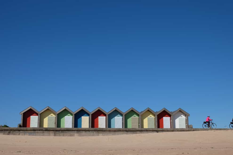 A clear blue sky over beach huts in Blyth, Northumberland