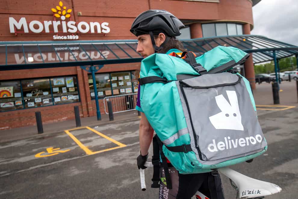 A Deliveroo rider outside a Morrisons supermarket