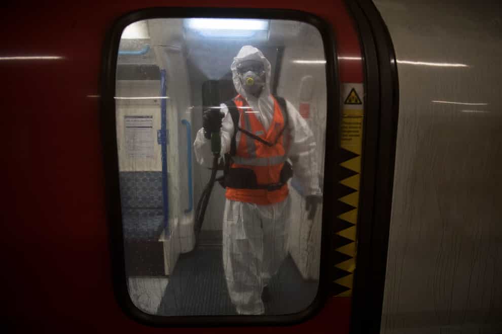 TfL worker sprays anti viral solution Zoono-71 inside a Tube train