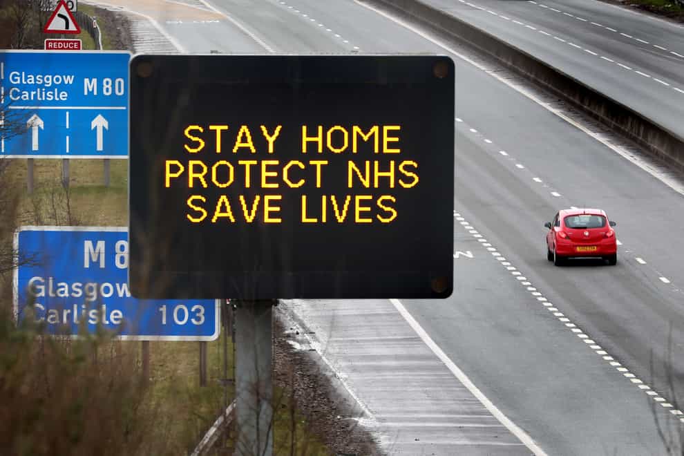 A motorway sign advising drivers to stay home, protect the NHS and save lives