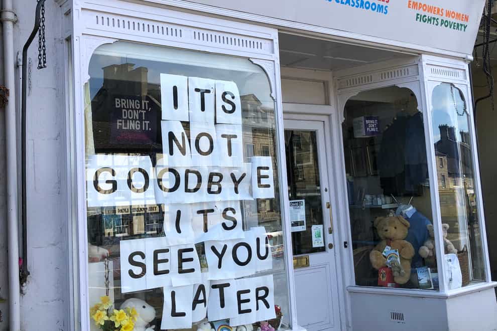 A sign in the window of an Oxfam shop
