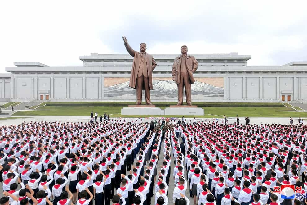 Bronze statues depict the celebrated founder (left) and his late son Kim Jong-il
