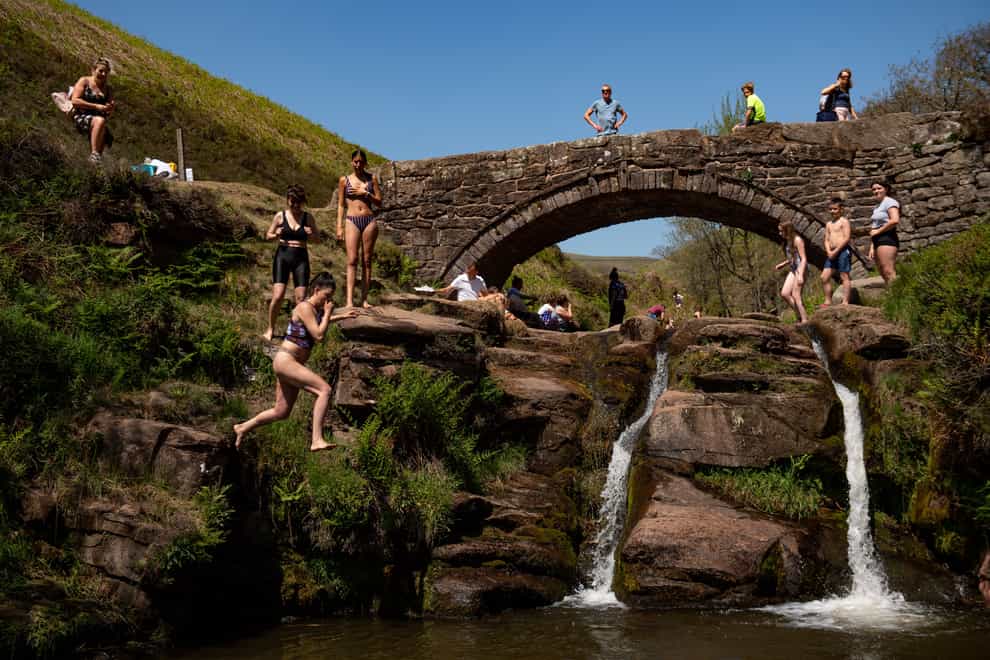 People enjoying the good weather by Three Shires Head on the River Dane, where Cheshire, Derbyshire and Staffordshire meet (Jacob King/PA)