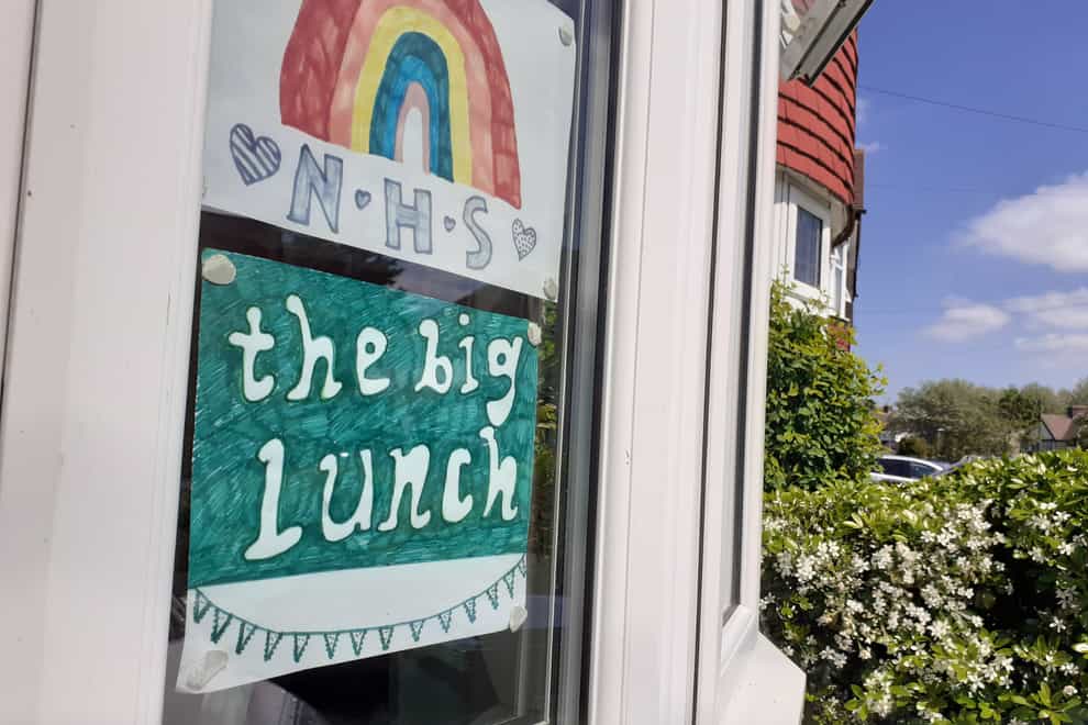 An NHS rainbow poster and a Big Lunch poster