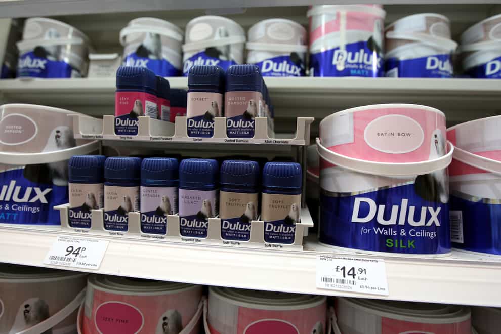Tins of Dulux paint in a B&Q store