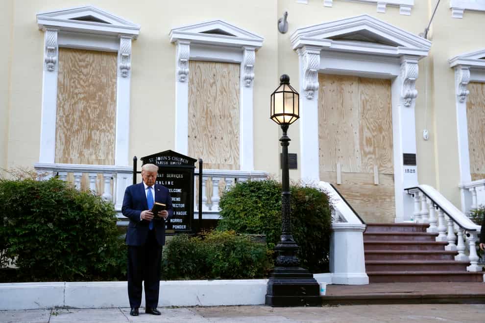 President Donald Trump holds a bible outside St John’s Church in Washington DC