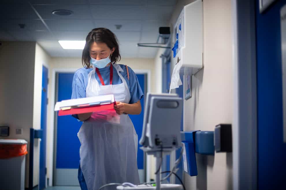 A doctor checks on patient notes