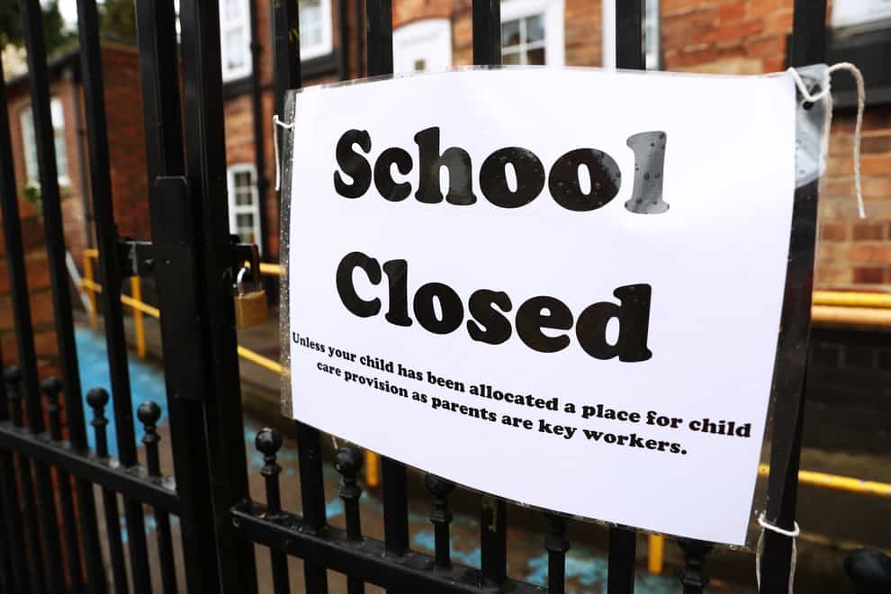 A closed sign on school gates