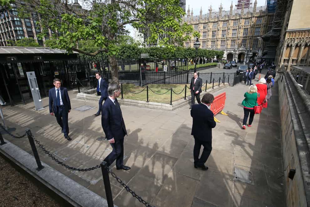 MPs queue outside the Commons as they wait to vote