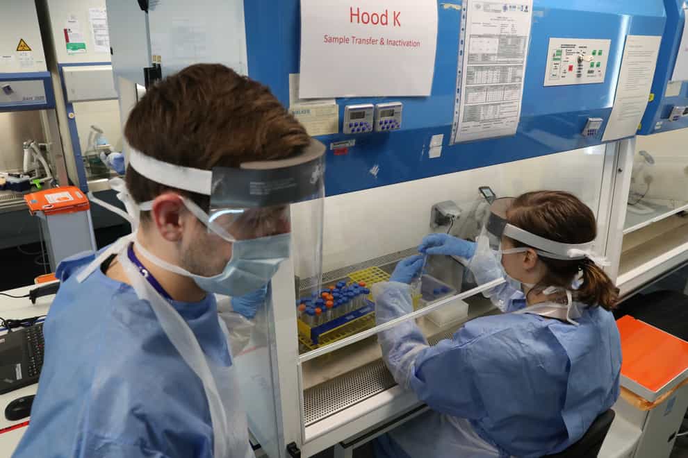 Technicians carry out coronavirus test