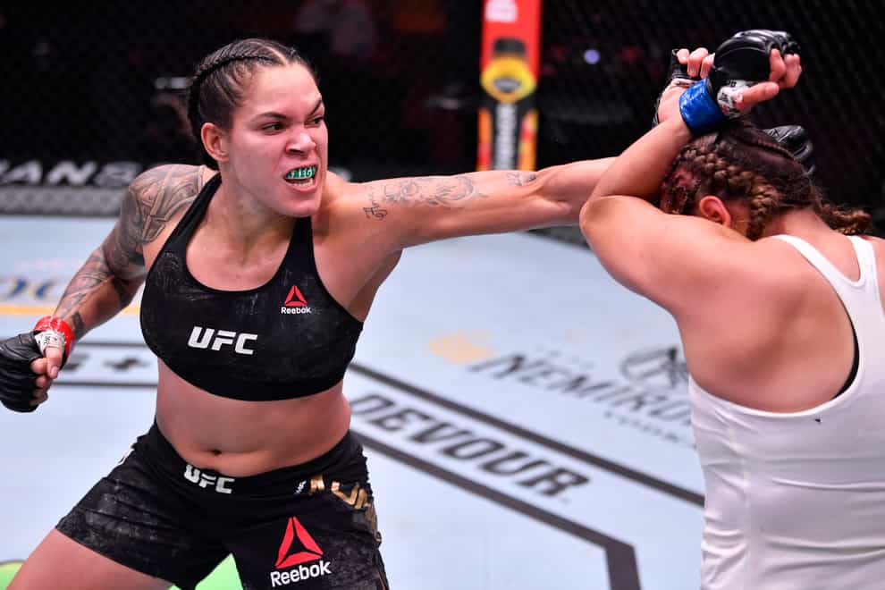 Amanda Nunes of Brazil punches Felicia Spencer of Canada in their UFC featherweight championship bout during UFC 250