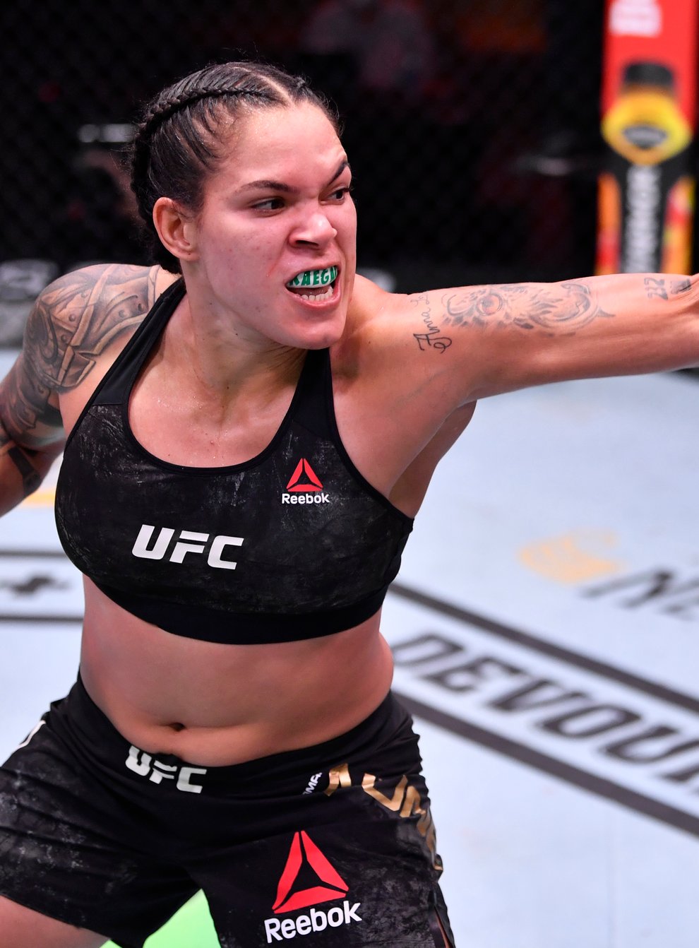 Amanda Nunes of Brazil punches Felicia Spencer of Canada in their UFC featherweight championship bout during UFC 250