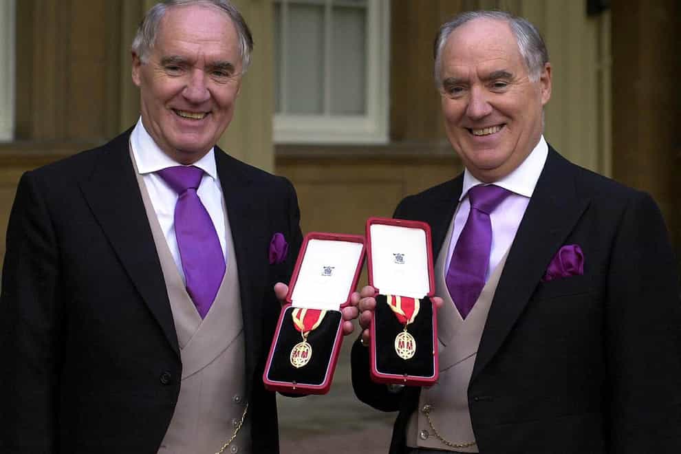 Sir David Barclay and his twin brother Sir Frederick Barclay after receiving their knighthoods at Buckingham Palace