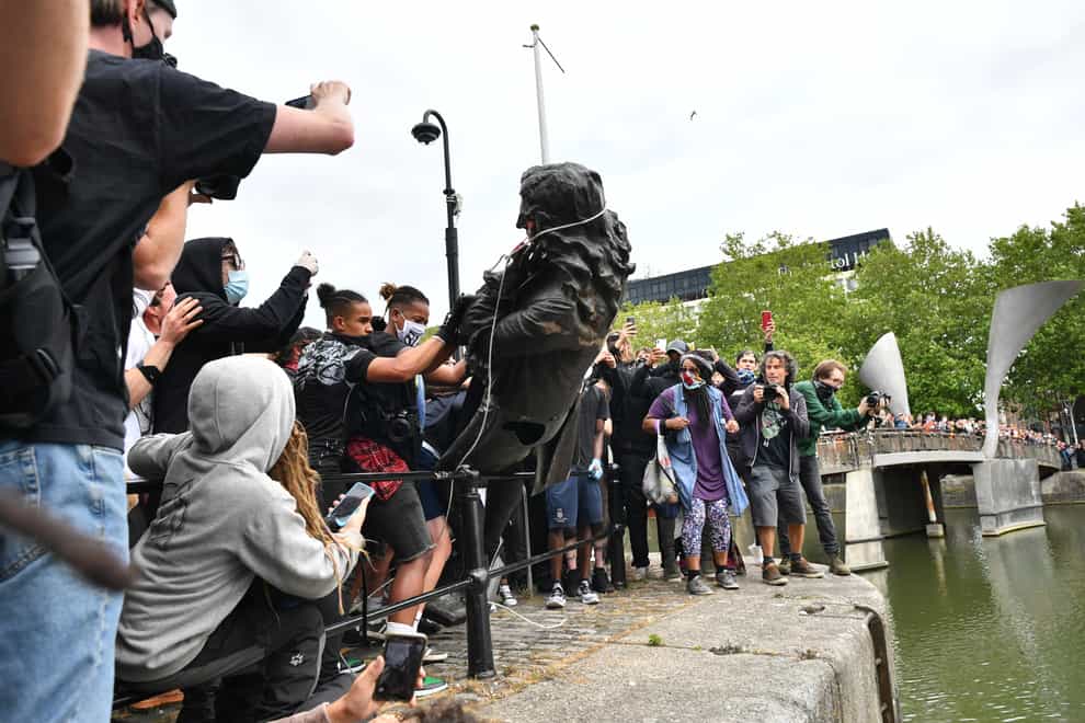 The statue of Edward Colston is thrown into Bristol harbour