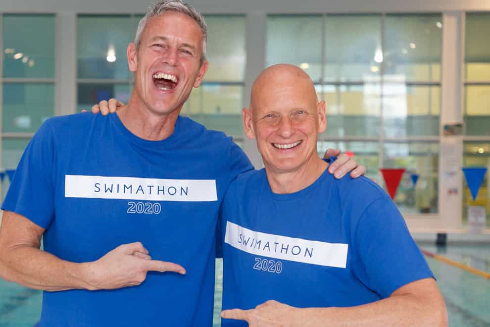 Mark Foster, left, works with the Swimathon Foundation