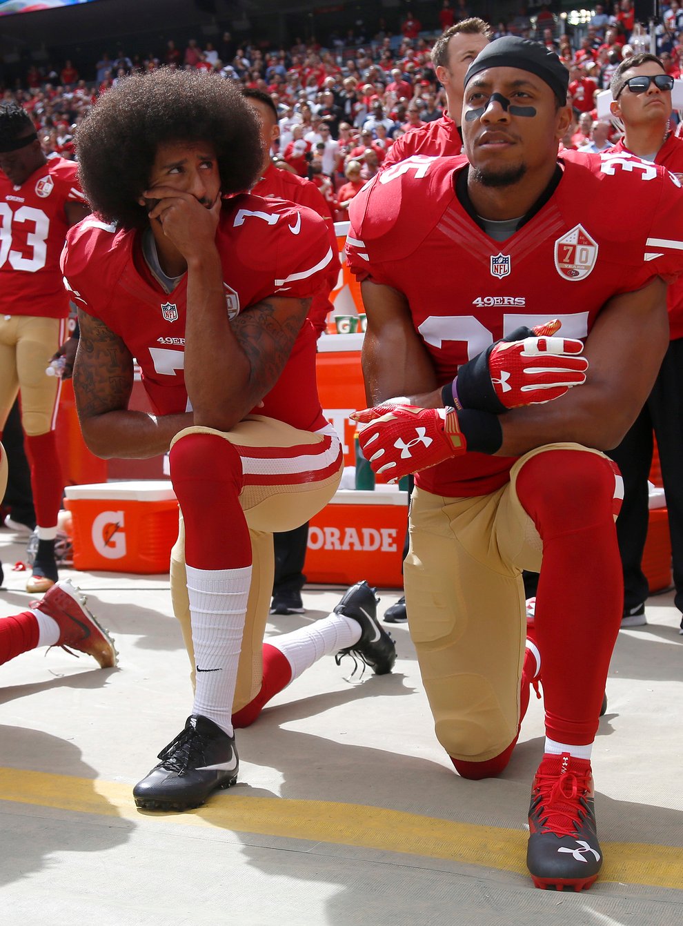 Kaepernick (centre) famously knelt during the national anthem in 2016