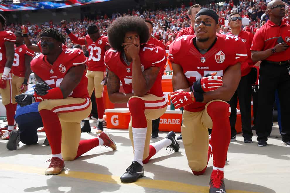 Kaepernick (centre) famously knelt during the national anthem in 2016