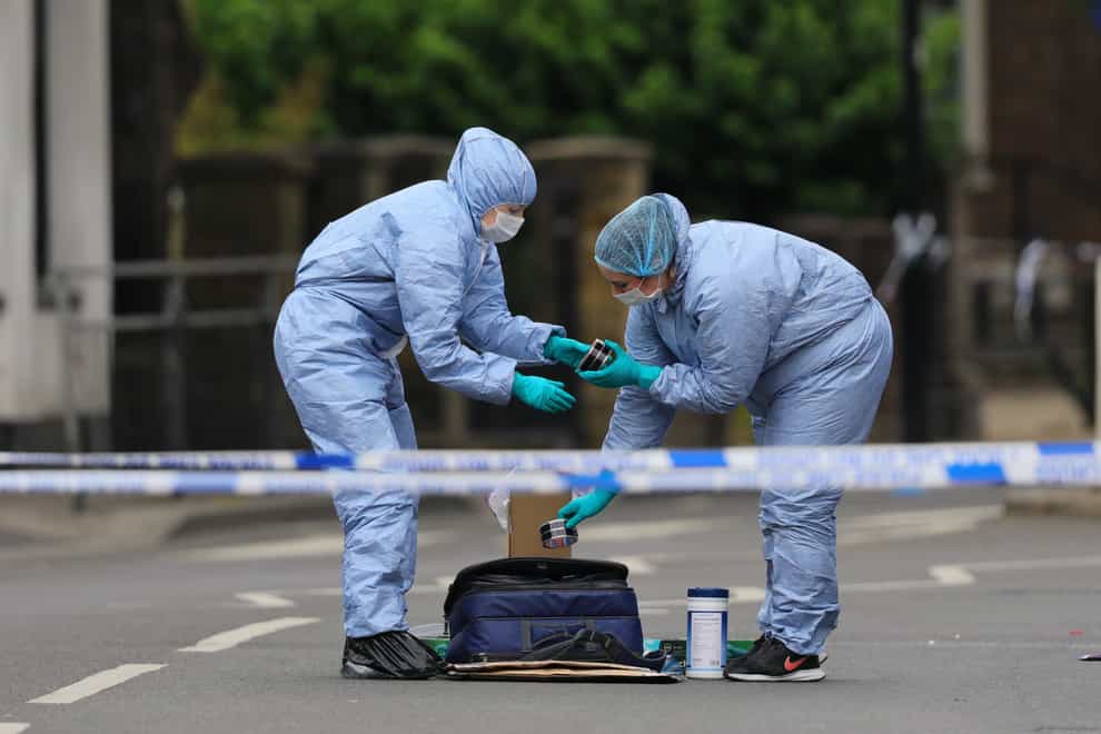 Forensic officers in Askew Road, Shepherd’s Bush, west London, as a murder investigation has been launched after a man was shot dead