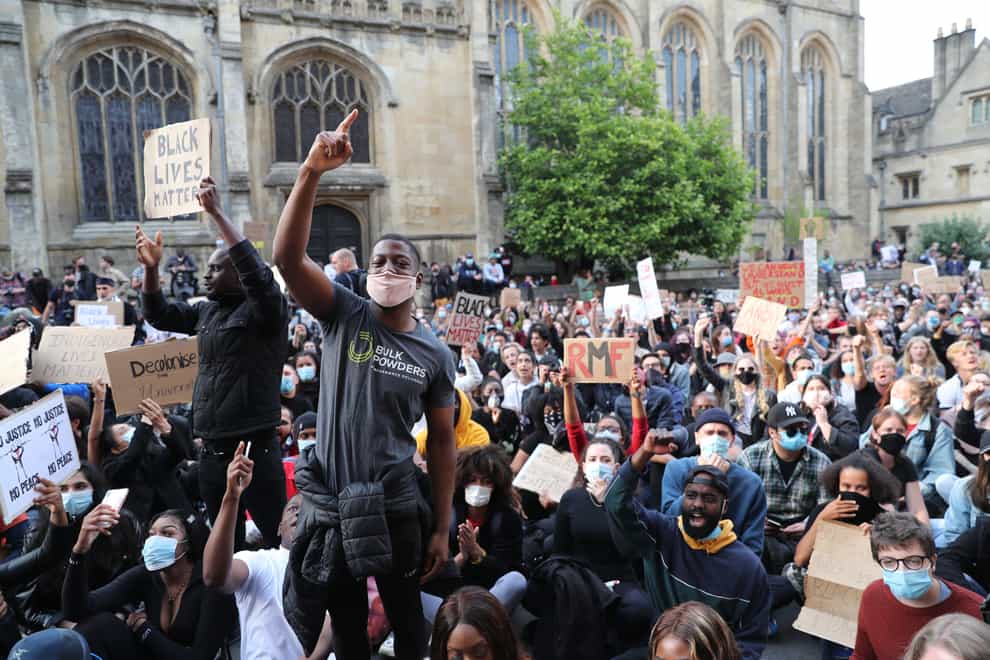Protesters call for the removal of the statue of 19th century imperialist Cecil Rhodes from an Oxford college