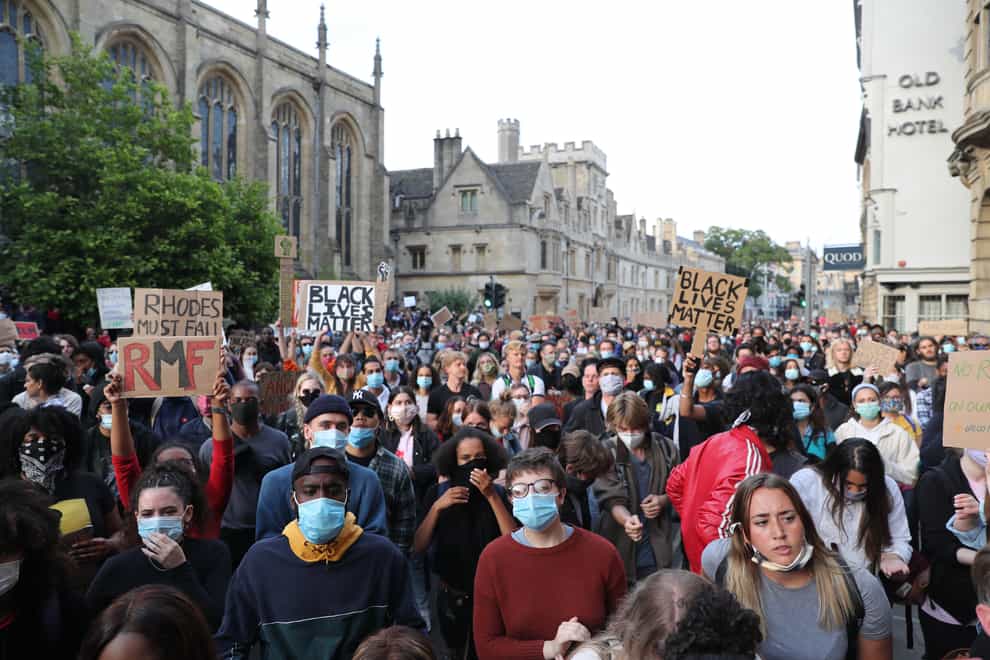 People during a protest calling for the removal of the statue of 19th century imperialist, politician Cecil Rhodes from an Oxford college