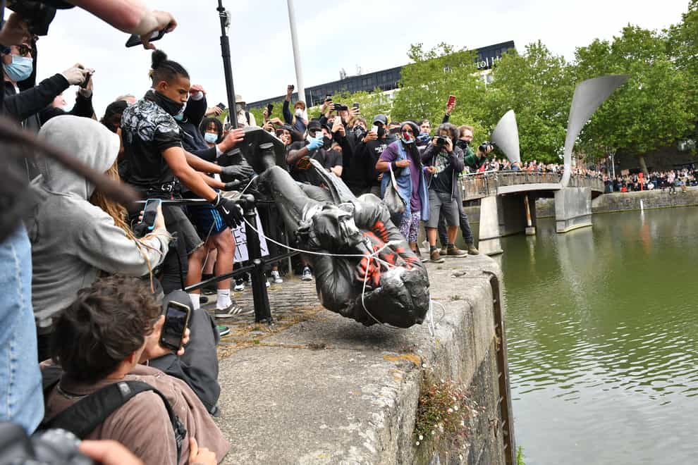 The moment protesters throw the statue of Edward Colston into Bristol harbour during a Black Lives Matter protest rally 