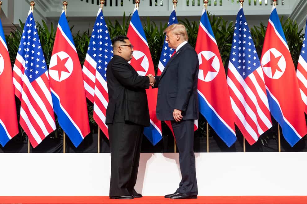 President Donald Trump shakes hands with Kim Jong un two years ago in Singapore