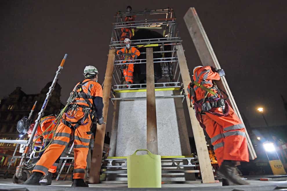 Scaffolders erect boarding around the statue of Sir Winston Churchill in Parliament Square, London 
