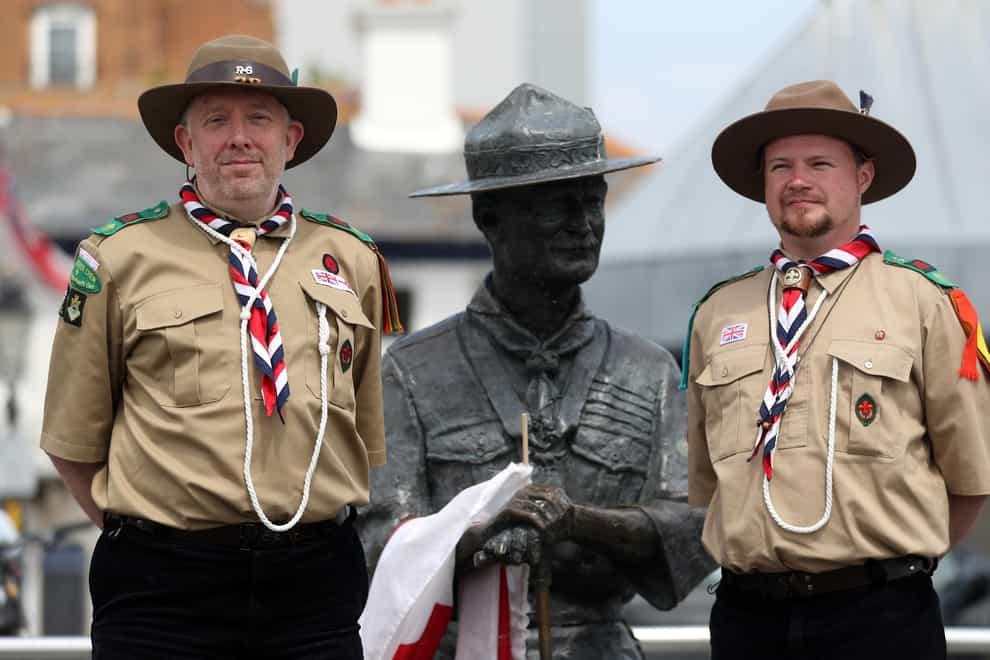 Rover Scouts Chris Arthur and Matthew Trott stand in front of the statue (Andrew Matthews/PA)