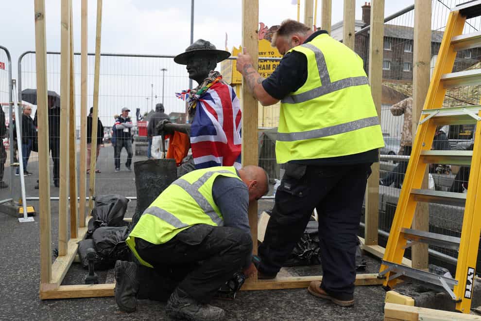 Council workers board up a statue of Robert Baden-Powell