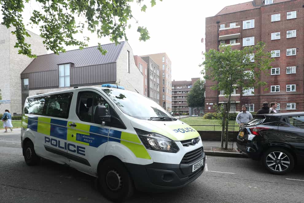 A police van driving past the scene in Frampton Park Road, Hackney, east London