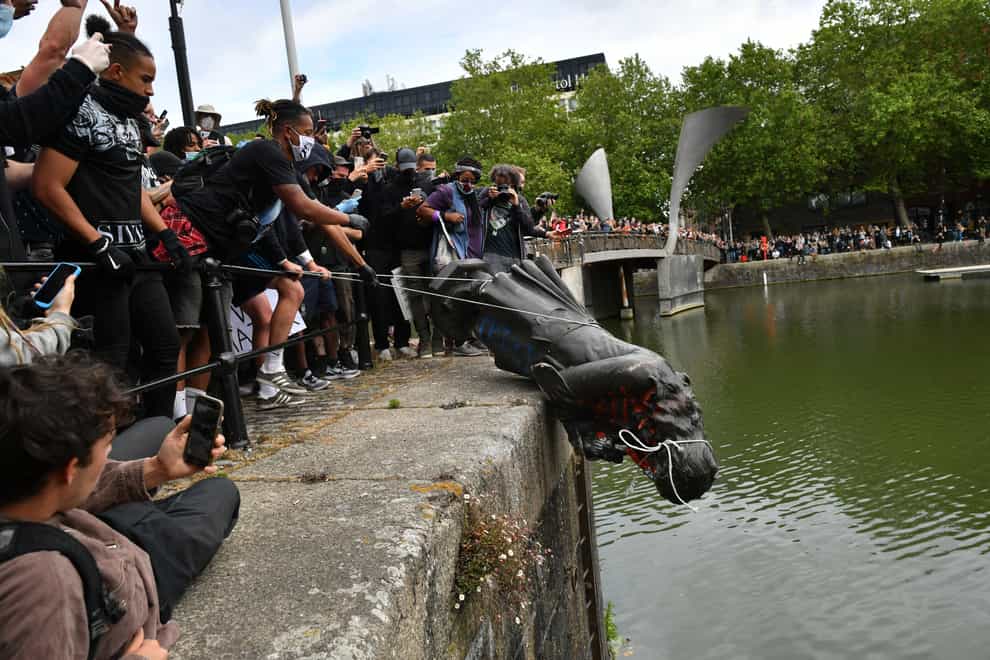 Protesters throw the statue into Bristol Harbour (Ben Birchall/PA)