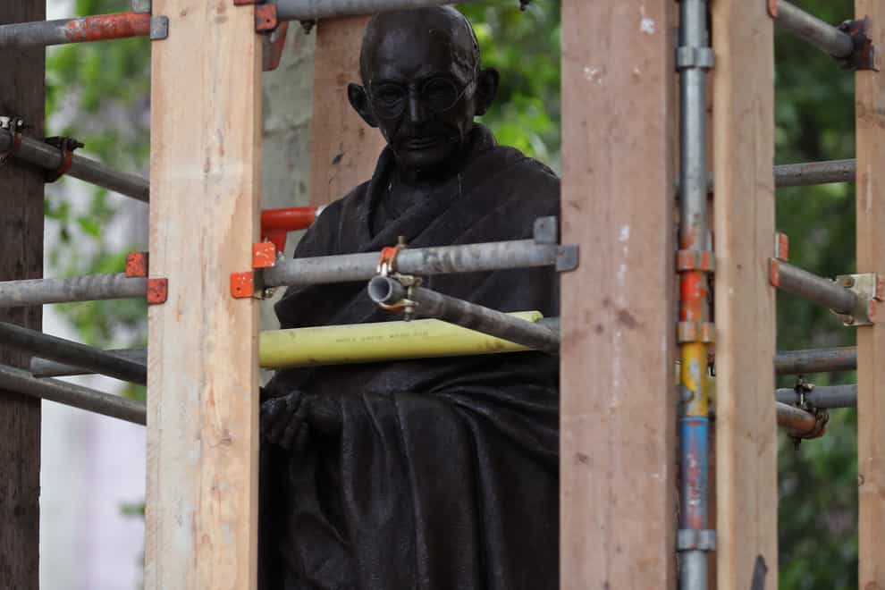 The statue of Mahatma Gandhi in Parliament Square, London, is boarded up