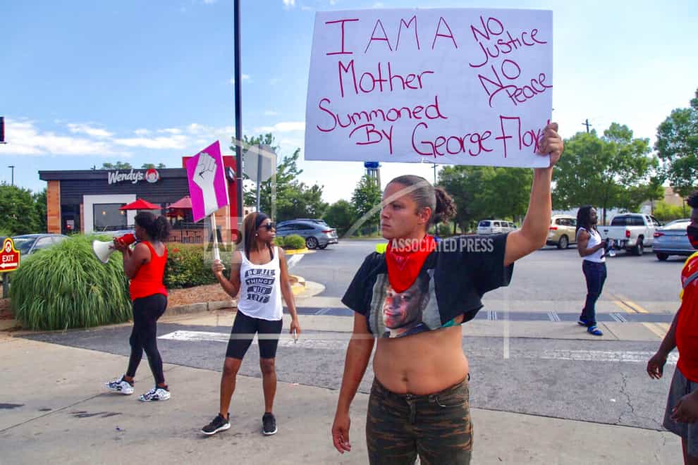 Protesters gather outside the Wendy's fast food restaurant in Atlanta on Saturday where Rayshard Brooks, a 27-year-old black man, was shot and killed by Atlanta police during a struggle in a drive-thru 