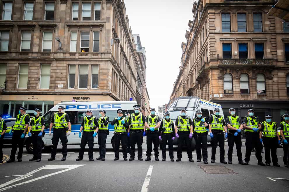 Police hold back protesters at a demonstration organised by the Loyalist Defence League in George Square, Glasgow