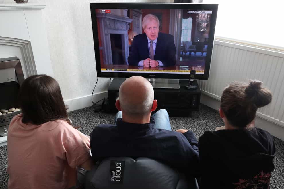People watch Prime Minister Boris Johnson addressing the nation about coronavirus