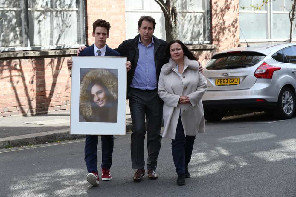 Nadim and Tanya Ednan-Laperouse with their son Alex holding a picture of Natasha Ednan-Laperouse