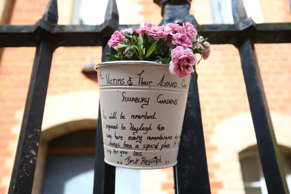 Flowers and a message left at the Abbey gateway of Forbury Gardens in Reading town centre